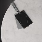 Top view of black and grey ID card mockups with a grey lanyard on a marble surface ideal for branding and presentation resources for graphic designers.