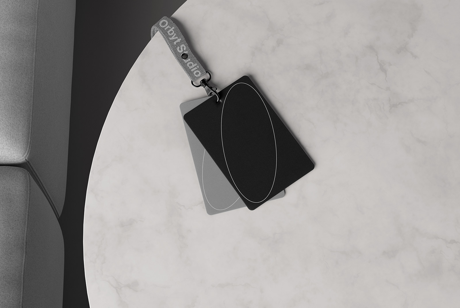 Top view of black and grey ID card mockups with a grey lanyard on a marble surface ideal for branding and presentation resources for graphic designers.