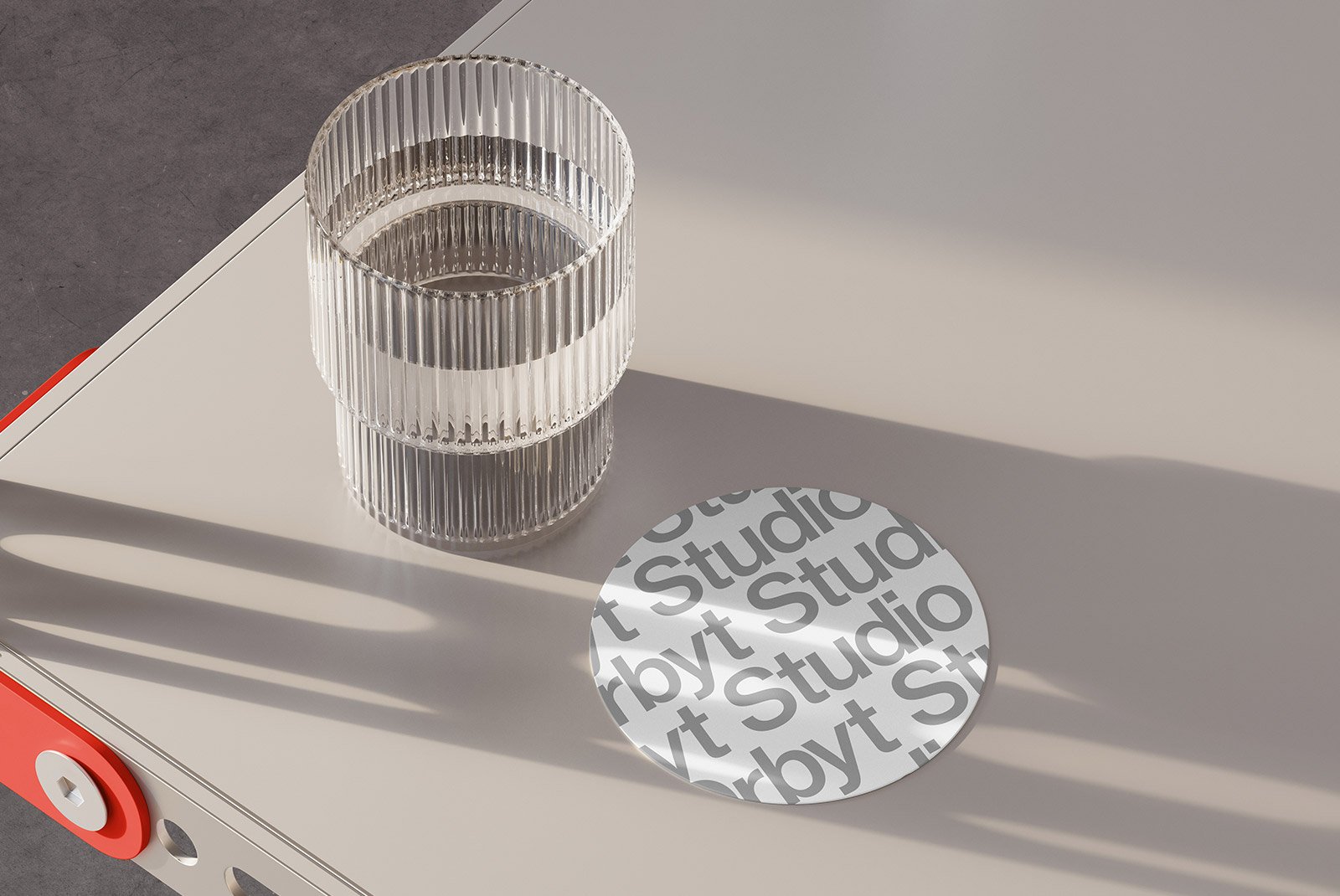 Glass on modern table with stylish coaster design featuring the text Studio ideal for graphic designers digital assets print mockups branding presentations