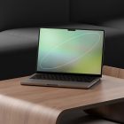 Laptop mockup on a wooden table in a modern office setting perfect for showcasing website designs or app interfaces for graphic designers and digital assets.