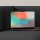 Modern laptop with colorful abstract screen on dark sofa digital asset for designers tech mockups high-quality stock images for graphic design projects