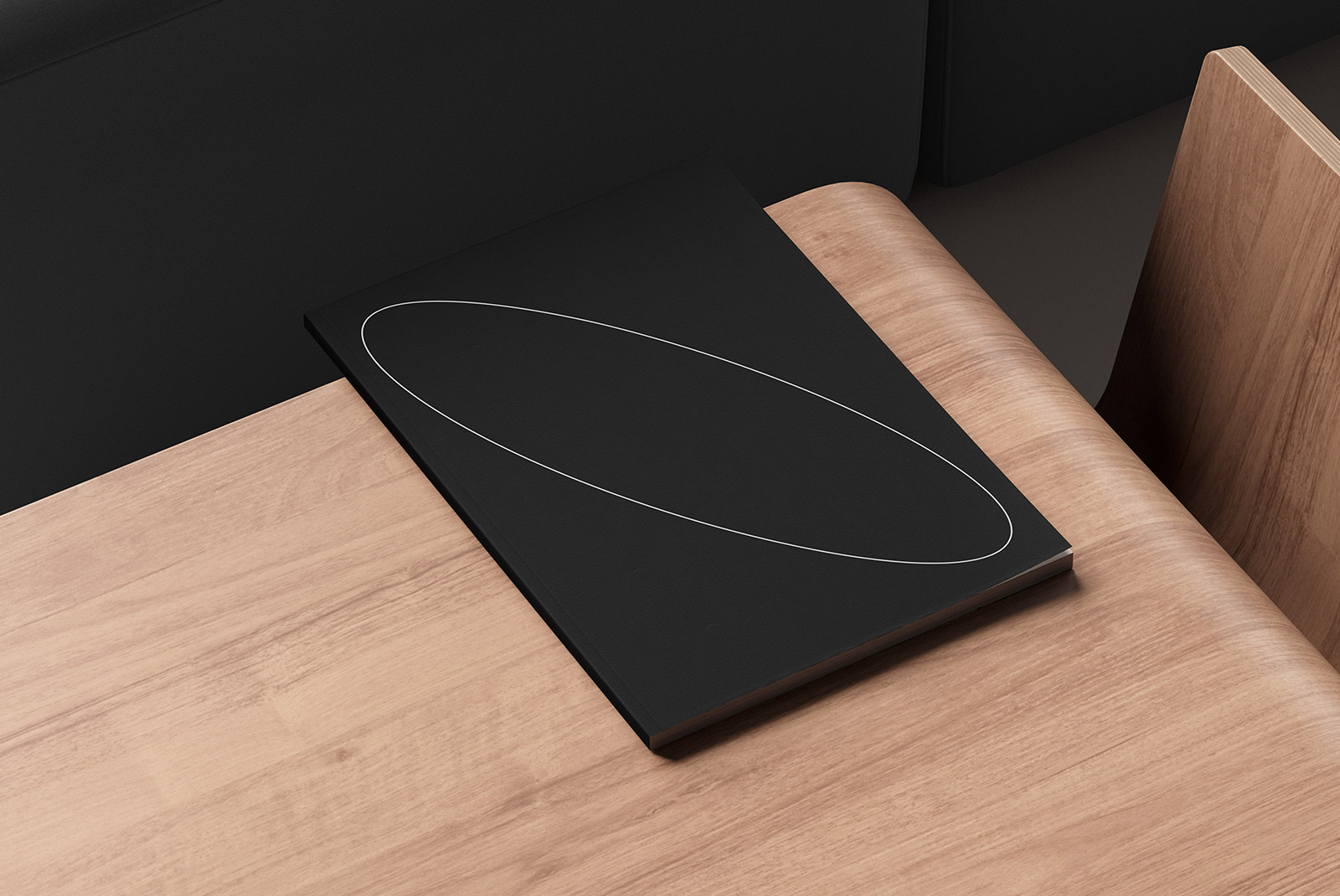 Black print mockup book on a wooden desk with minimalistic design suitable for digital assets store geared towards graphic designers and mockup resources.