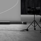 Silhouette of a cameraman by a large screen background in a studio setting, ideal for tech mockups print mockups packaging mockups and graphic design assets.