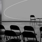 Monochrome tech mockup featuring a minimalist setup with black chairs and table. Ideal for graphic designers, print visuals, packaging, and digital assets.