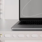 Tech mockup of a sleek laptop placed on a modern metal shelf ideal for graphic designers and digital asset creators showcasing hardware and workspace setups