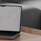 Laptop mockup on a wooden desk with a modern gray background perfect for tech mockups and showcasing design projects for graphic designers.