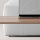 Tech mockup featuring a sleek laptop on a wooden desk with minimalist design and a white background ideal for graphic designers digital assets and presentations.