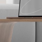 Wooden laptop stand on grey couch setup tech mockup featuring minimalist design and modern workspace for graphic designers and digital artists.