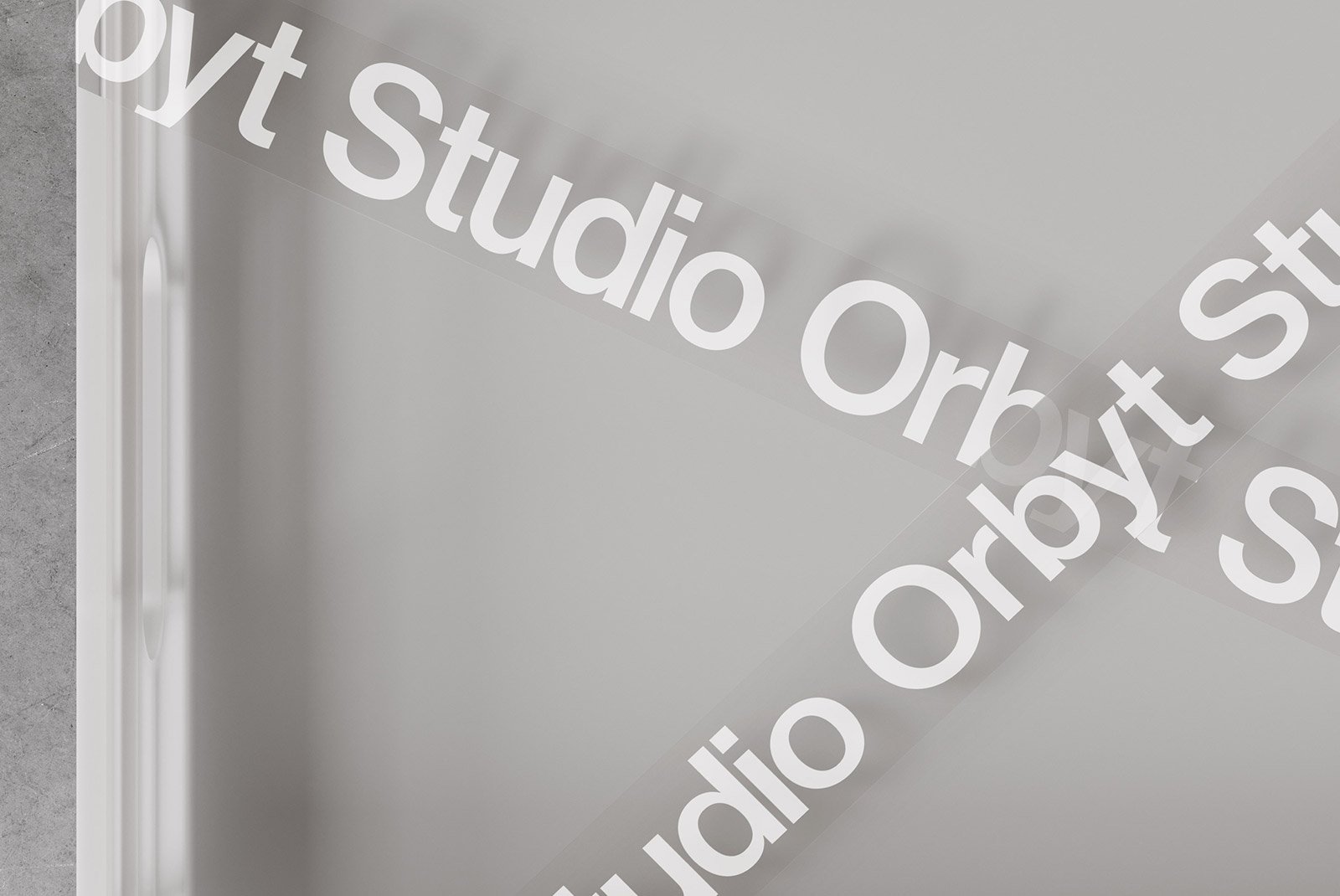 Modern packaging mockup with minimalistic design featuring the text Studio Orbyt repeated diagonally across a clean grey background. Graphic design asset.